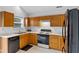 Functional kitchen with oak cabinets, white countertops, black appliances, and ample storage space, perfect for everyday cooking at 5503 Wilder Way, Indianapolis, IN 46216