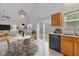 Open kitchen with dining area, stainless dishwasher, and sliding glass doors providing abundant natural light and access to the backyard at 5503 Wilder Way, Indianapolis, IN 46216