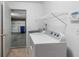 Bright laundry room with shelving, washer, dryer, and access to the garage at 5503 Wilder Way, Indianapolis, IN 46216