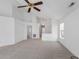 Open-concept living space featuring vaulted ceilings, neutral carpet, and multiple entry points, ideal for flexible living at 5503 Wilder Way, Indianapolis, IN 46216