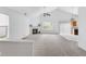 Spacious living room featuring a fireplace, large windows, and access to the kitchen, perfect for entertaining at 5503 Wilder Way, Indianapolis, IN 46216