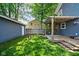 Spacious backyard featuring a well-maintained lawn, a detached garage, and a lovely pergola-covered deck at 609 E 39Th St, Indianapolis, IN 46205