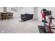Versatile finished basement featuring a cozy couch, dining set, and exercise equipment, perfect for various activities at 609 E 39Th St, Indianapolis, IN 46205