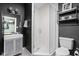 Modern bathroom with glass enclosed shower, updated vanity and fixtures, plus dark accent walls at 609 E 39Th St, Indianapolis, IN 46205