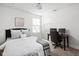 Bright bedroom featuring a comfortable bed with plush pillows and a dedicated workspace with dual monitors at 609 E 39Th St, Indianapolis, IN 46205