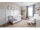 Charming Bedroom with a crib, comfortable armchair, and playful giraffe decor, perfect for a cozy and inviting space at 609 E 39Th St, Indianapolis, IN 46205