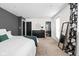 Spacious bedroom features neutral carpet, large mirror, and dark wood dresser at 609 E 39Th St, Indianapolis, IN 46205
