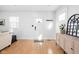 Bright entryway featuring hardwood floors, a stylish cabinet, and ample natural light at 609 E 39Th St, Indianapolis, IN 46205