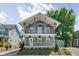 Charming two-story home featuring dual balconies, light blue siding, and a well-manicured front yard at 609 E 39Th St, Indianapolis, IN 46205