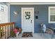 Inviting front porch with a white door, potted flowers, and charming decor at 609 E 39Th St, Indianapolis, IN 46205