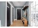 Cozy hallway with storage bench, pantry access, coat hooks and door to outside at 609 E 39Th St, Indianapolis, IN 46205