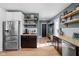 Stylish kitchen showcases butcher block counters, stainless steel appliances, open shelving, and bar seating at 609 E 39Th St, Indianapolis, IN 46205