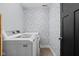 Efficient laundry room with modern appliances and stylish wallpaper, making chores a breeze at 609 E 39Th St, Indianapolis, IN 46205