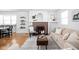 Cozy living room showcasing a brick fireplace, hardwood floors, and neutral decor at 609 E 39Th St, Indianapolis, IN 46205