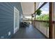 Covered patio features tile floor, wood columns, and outdoor furniture at 609 E 39Th St, Indianapolis, IN 46205