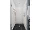 Beautiful glass enclosed shower with white subway tile and black penny tile floor at 609 E 39Th St, Indianapolis, IN 46205