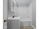 Clean bathroom with new fixtures, tile floor, and updated shower/tub combo at 618 Miller Ave, Shelbyville, IN 46176