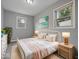 Stylishly decorated bedroom with grey walls, hardwood floors and a metal bed frame exudes a soothing and sophisticated atmosphere at 618 Miller Ave, Shelbyville, IN 46176