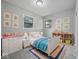 Cozy bedroom features a white bed, light gray walls, hardwood floors and colorful decor, perfect for a  at 618 Miller Ave, Shelbyville, IN 46176