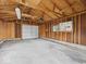 Spacious garage interior with concrete floor and exposed wooden beams at 618 Miller Ave, Shelbyville, IN 46176