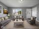 Inviting living room with neutral tones, comfortable seating, and a view to the outside at 618 Miller Ave, Shelbyville, IN 46176