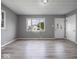 Bright and airy living room with large windows, neutral paint and hardwood flooring at 618 Miller Ave, Shelbyville, IN 46176