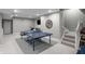Finished basement featuring a ping pong table and stairs leading to the upper level at 654 N Senate Ave, Indianapolis, IN 46202