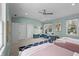 Spacious bedroom with ceiling fan, large windows, and dual built-in desk areas at 654 N Senate Ave, Indianapolis, IN 46202