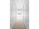 Spacious walk-in closet with ample storage, featuring built-in shelves and drawers and neutral carpeting at 654 N Senate Ave, Indianapolis, IN 46202