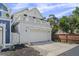 Two-story home with a white garage, a balcony, and a well-maintained driveway at 654 N Senate Ave, Indianapolis, IN 46202