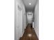 Hallway with hardwood floors leading to several rooms, featuring white trim and neutral walls at 654 N Senate Ave, Indianapolis, IN 46202
