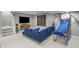 Cozy living room with a comfortable blue sectional couch and mounted television in the basement at 654 N Senate Ave, Indianapolis, IN 46202