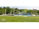 Picturesque playground with colorful equipment surrounded by lush greenery and mature trees at 654 N Senate Ave, Indianapolis, IN 46202