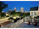 Balcony view of the Indianapolis skyline at night, surrounded by lush trees at 654 N Senate Ave, Indianapolis, IN 46202