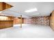 A spacious finished basement with carpet, wood paneling, and support beam at 659 Carson Ct, Carmel, IN 46033