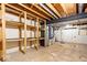 Unfinished basement area with exposed ductwork, utility equipment, and functional shelving for storage at 659 Carson Ct, Carmel, IN 46033