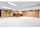 A spacious finished basement featuring wood paneling, and white carpet at 659 Carson Ct, Carmel, IN 46033
