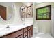Bright bathroom featuring double sinks, wood cabinets, white countertops, and natural light at 659 Carson Ct, Carmel, IN 46033