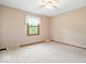 Cozy bedroom featuring neutral walls, plush carpeting, and natural light from the window at 659 Carson Ct, Carmel, IN 46033