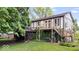 Charming Tudor-style home featuring a lush backyard, screened-in porch, and a spacious wooden deck at 659 Carson Ct, Carmel, IN 46033