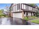 Exterior view of a Tudor-style home showcasing an attached garage and brick detailing at 659 Carson Ct, Carmel, IN 46033