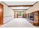 Spacious living room with a cozy fireplace and exposed beams at 659 Carson Ct, Carmel, IN 46033