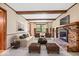 Inviting living room featuring a fireplace, exposed beams and plenty of seating at 659 Carson Ct, Carmel, IN 46033