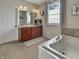 Bathroom featuring a soaking tub, double vanity, and ample natural light at 6693 W May Apple Dr, McCordsville, IN 46055