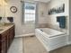 Bathroom with a soaking tub and vanity with double sinks at 6693 W May Apple Dr, McCordsville, IN 46055