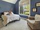 Well-lit bedroom with stylish decor and a cozy seating area at 6693 W May Apple Dr, McCordsville, IN 46055