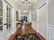 Traditional foyer featuring hardwood floors, white trim, and a view into the living spaces at 6693 W May Apple Dr, McCordsville, IN 46055