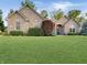 Charming brick home with a well-manicured lawn and mature landscaping at 6693 W May Apple Dr, McCordsville, IN 46055