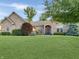 Beautiful single-story brick home featuring mature trees and lush green lawn at 6693 W May Apple Dr, McCordsville, IN 46055