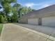 Spacious three-car garage with ample parking space and brick exterior at 6693 W May Apple Dr, McCordsville, IN 46055
